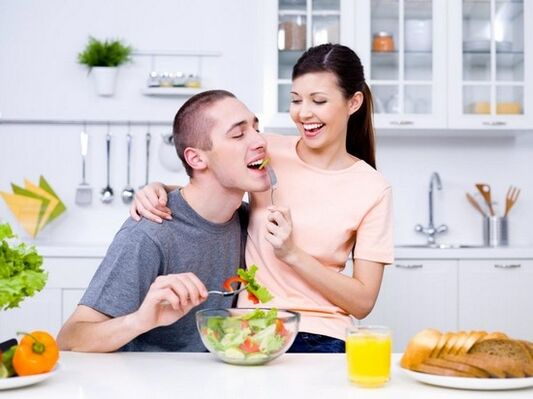The girl feeds her husband with products to increase potency