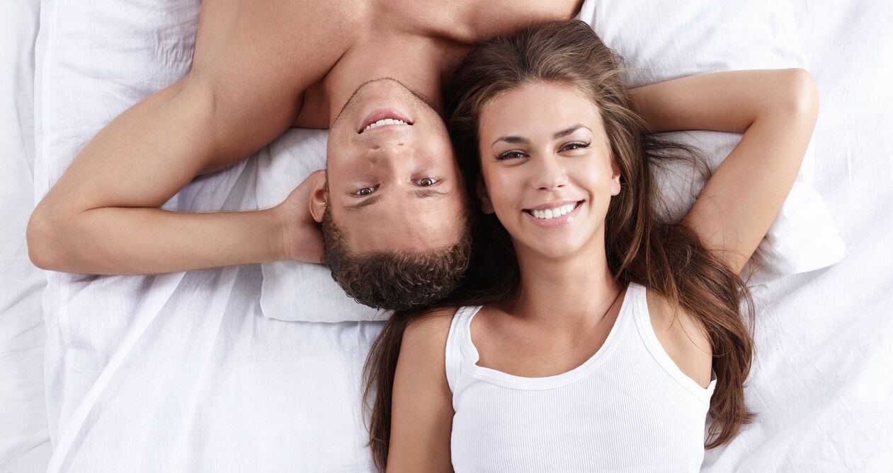 a woman in bed with a man with increased potency